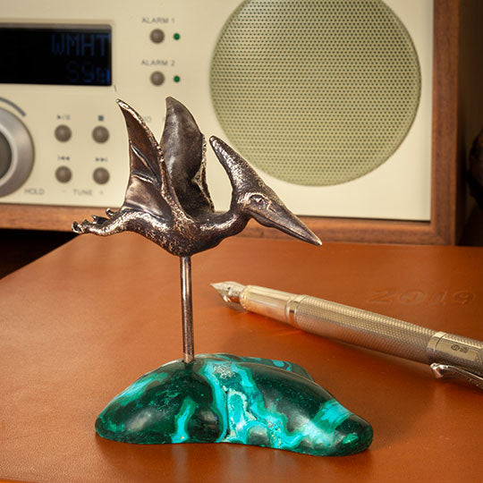 A Top-flight Pteranodon Desk Ornament on a malachite-chrysocolla