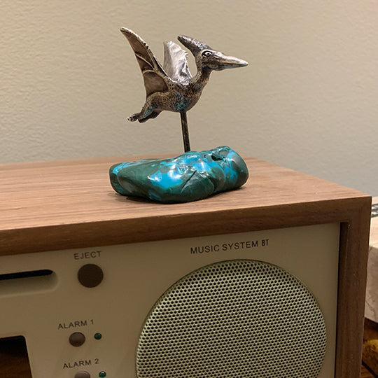 A Top-flight Pteranodon Desk Ornament on a malachite-chrysocolla base